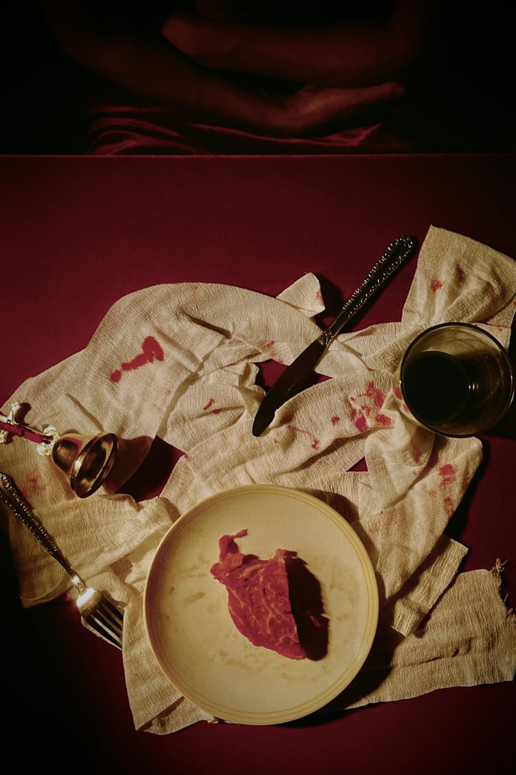 Raw Meat With Knife And Blood On Table