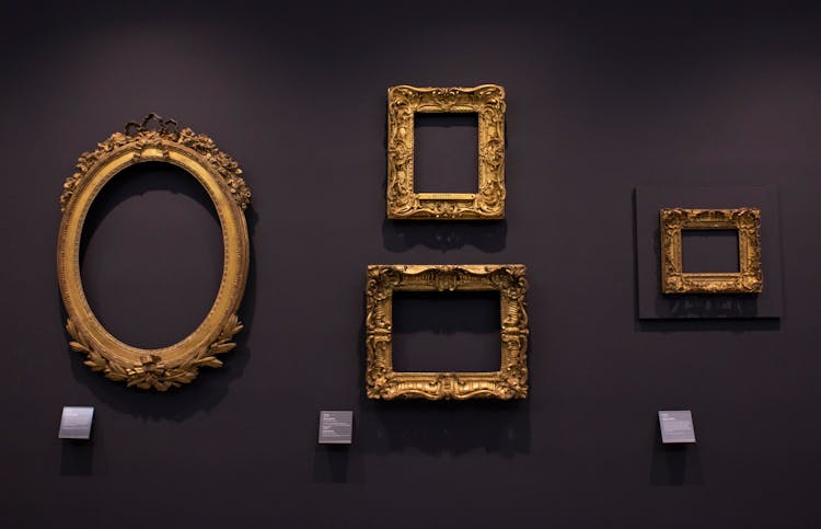 Antique Frames On Purple Wall 