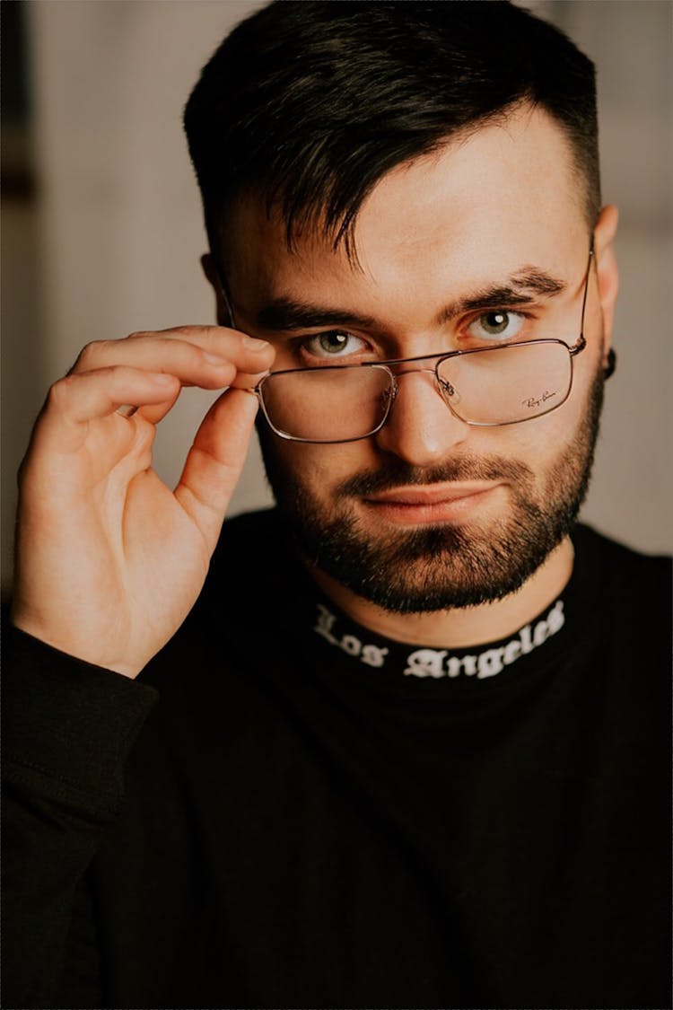 Portrait Of Man Taking Off Glasses