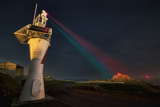 Lighthouse with Lights Beaming at Night