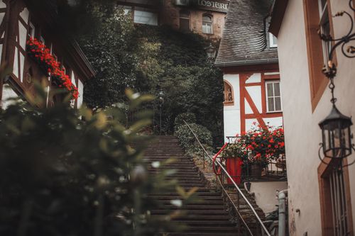 Free Picturesque stairway in a German village surrounded by traditional houses and summer blooms. Stock Photo