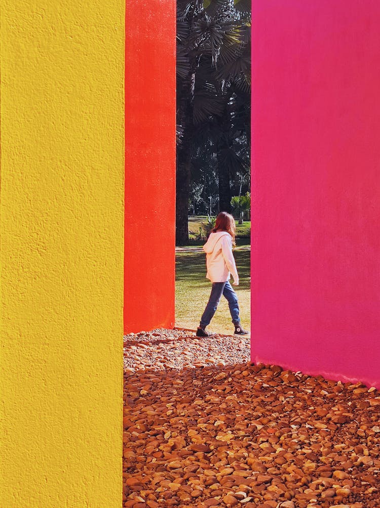 Person In White Hoodie Jacket Walking Between Painted Walls