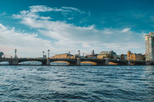 Free Anichkov Bridge spans the Fontanka River in St. Petersburg, a blend of architecture and natural beauty. Stock Photo