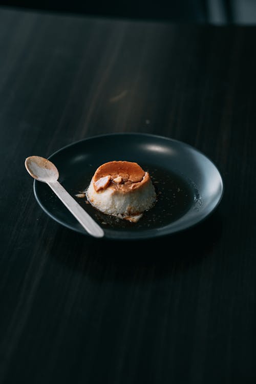 Free Burger on Black Ceramic Plate Beside Silver Spoon Stock Photo