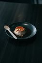 Burger on Black Ceramic Plate Beside Silver Spoon
