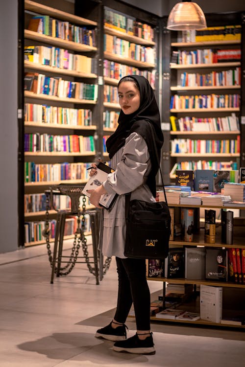 A Pretty Woman Inside a Library