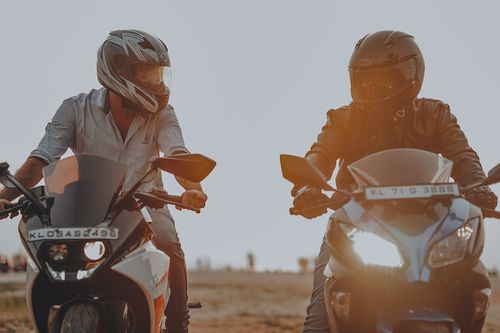 Free Two men riding motorcycles with helmets during sunset. Action and adventure concept outdoors. Stock Photo