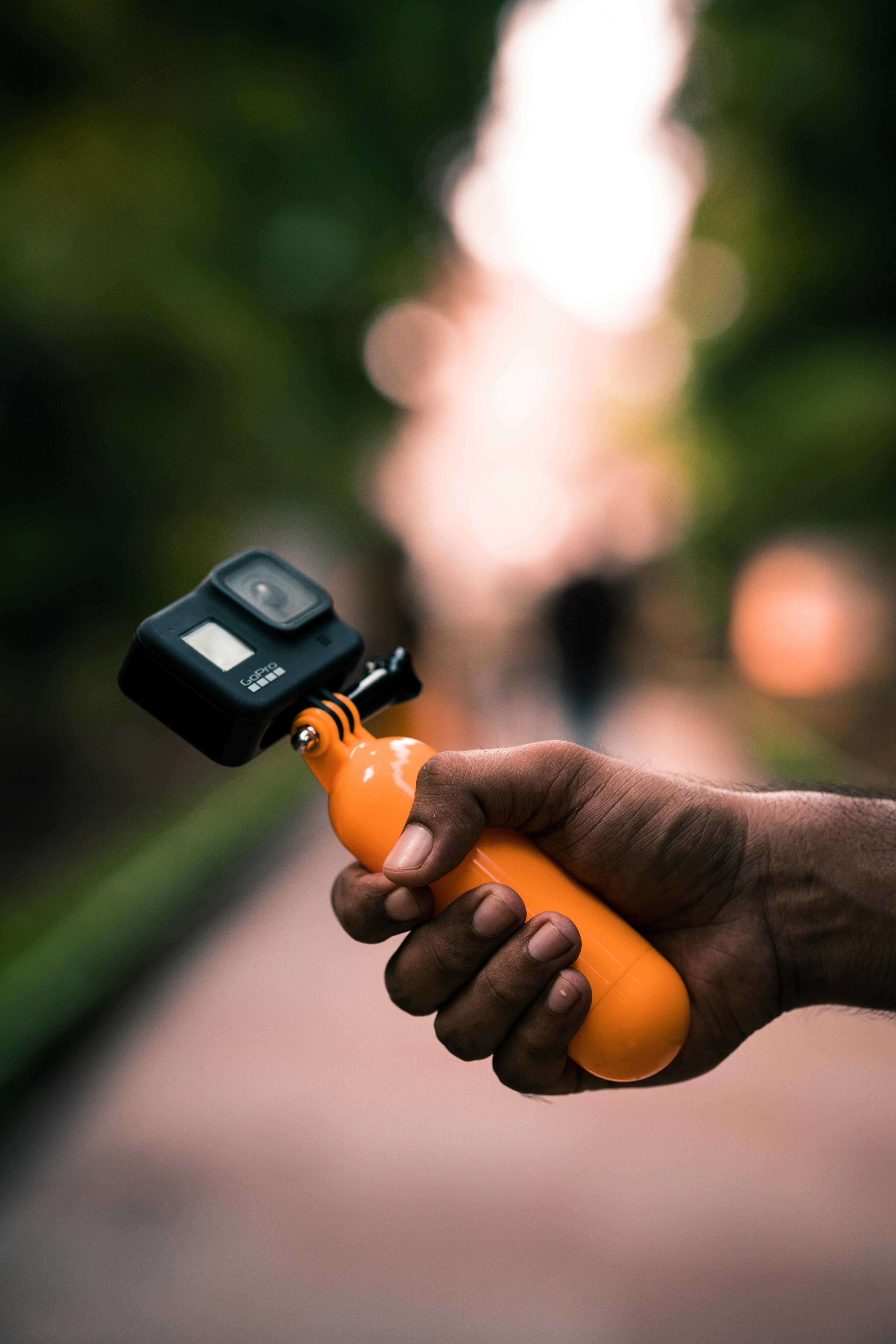 person holding a camera with floating handle