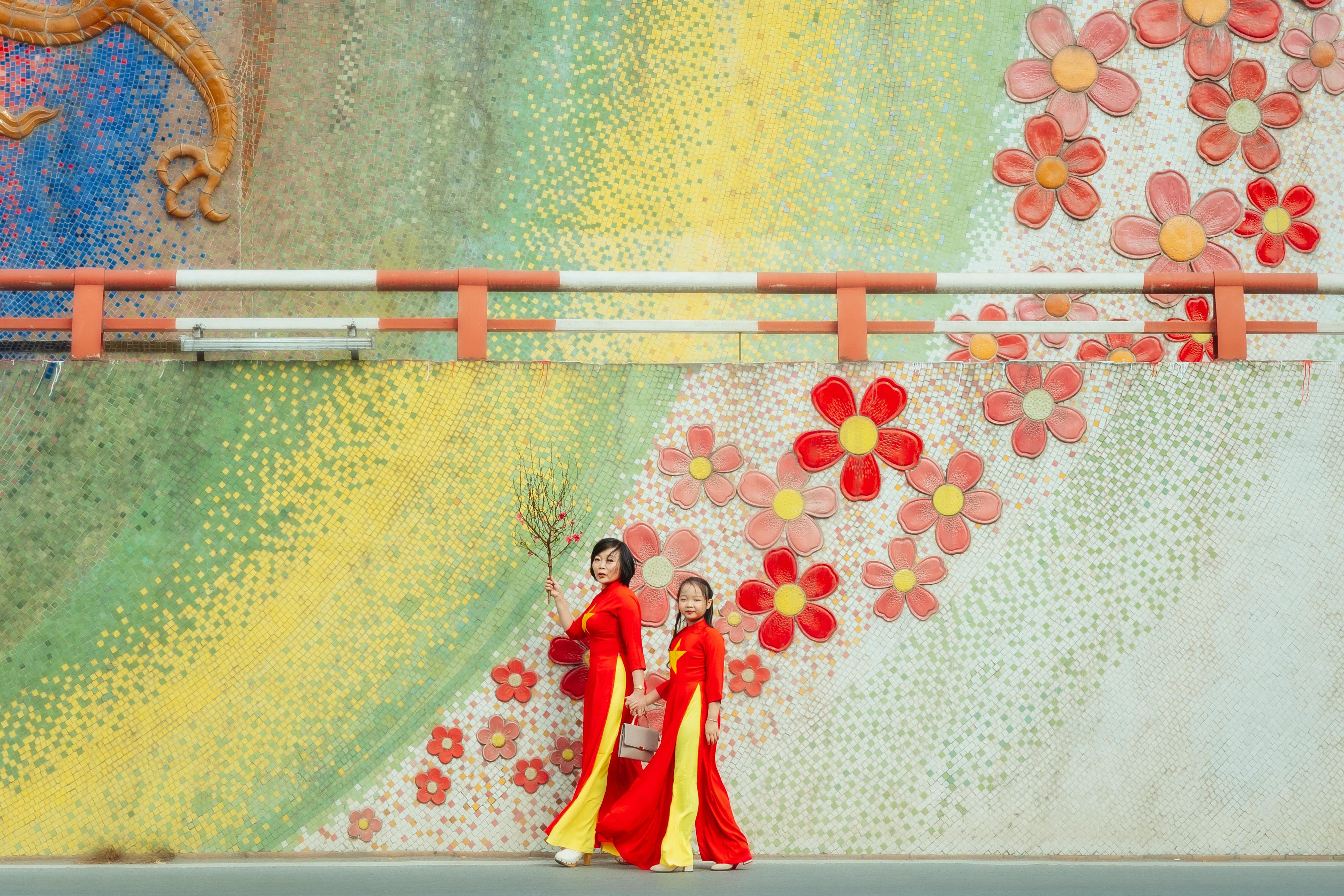 mother and daughter walking in traditional clothes