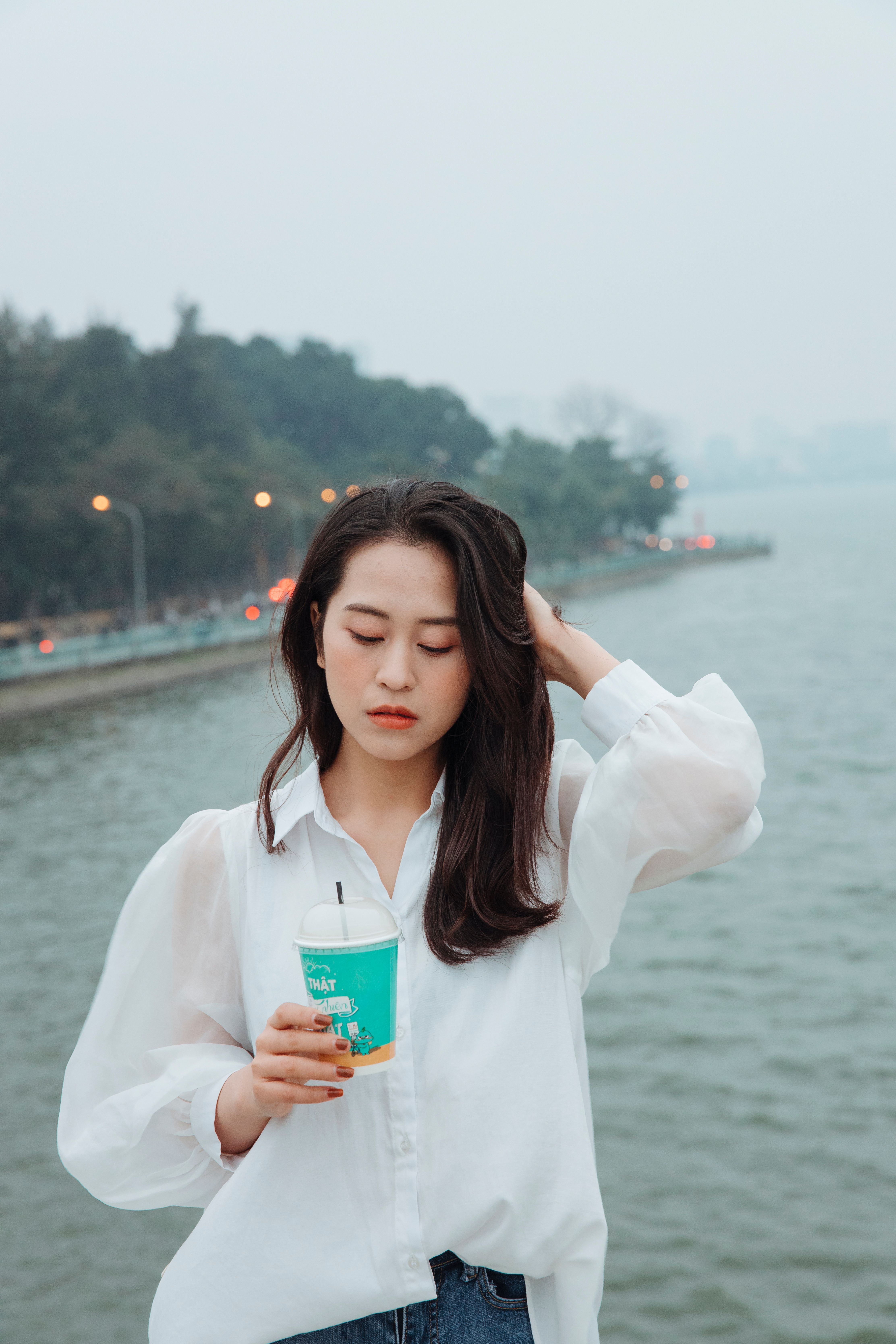 Woman in White Blouse Holding a Cup · Free Stock Photo