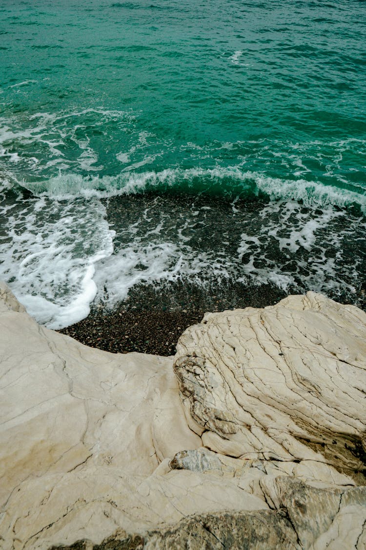 Sea Waves Crashing On Brown Rock