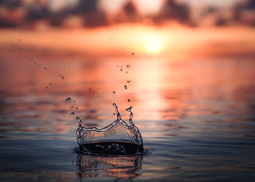 Free Captivating water splash with sunset background, capturing serenity in Hawaii. Stock Photo