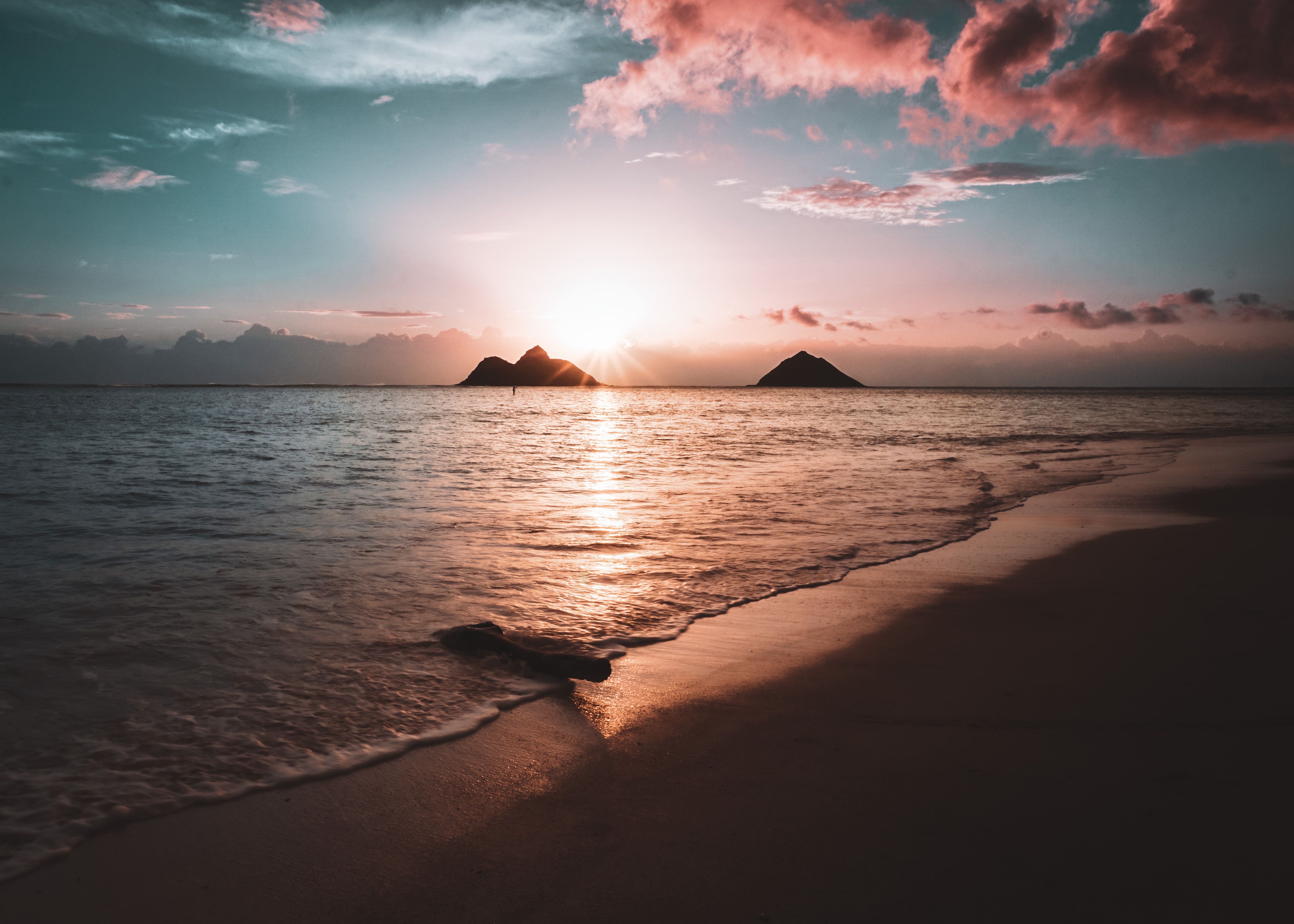 Sunrise glowing over the calm water at Lanikai Beach