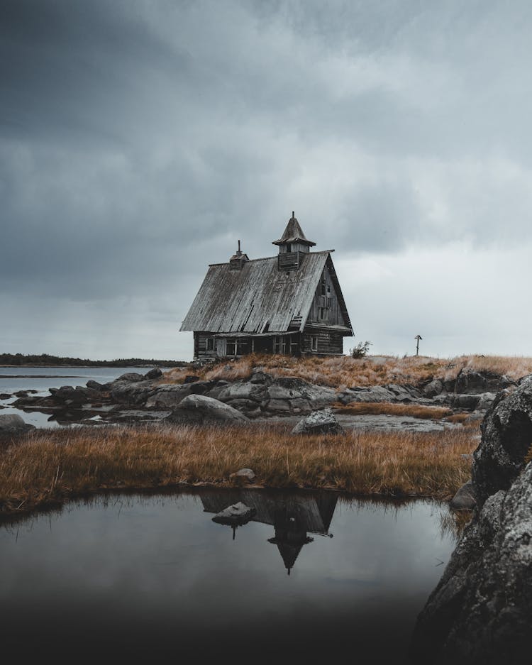 Abandoned Ruins Of Old Wooden Chapel At Lake Shore