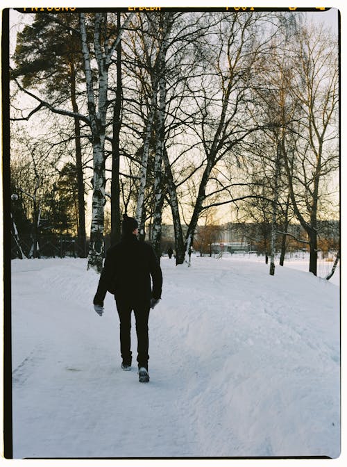 Free Man Walking on Snow Covered Ground Stock Photo