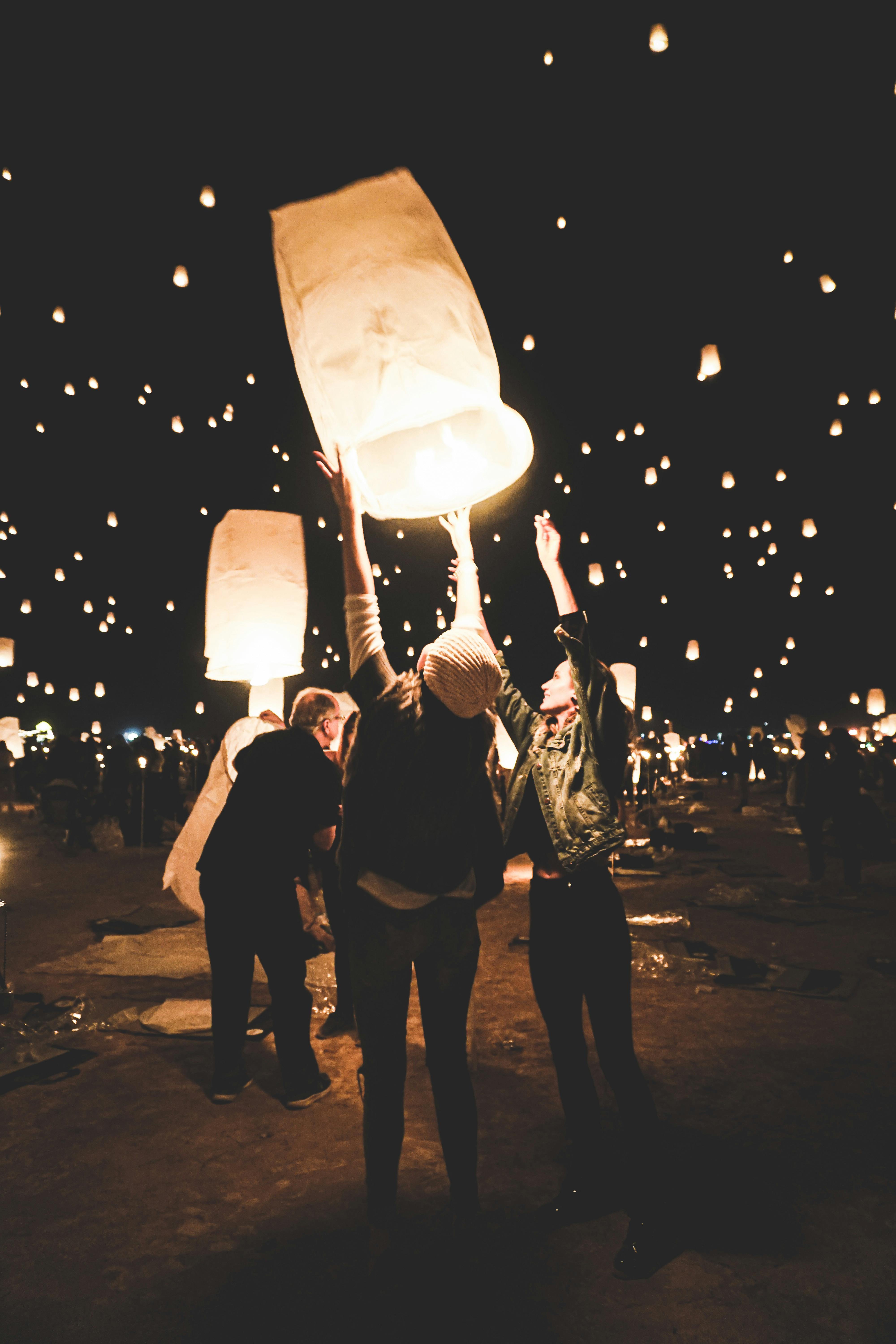 A man and a woman release a sky lantern at Dwarka during Diwali... News  Photo - Getty Images