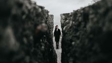 Woman Standing between Rocks