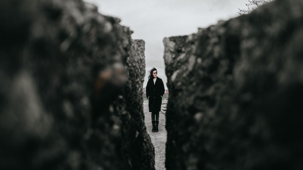 Woman Standing between Rocks · Free Stock Photo