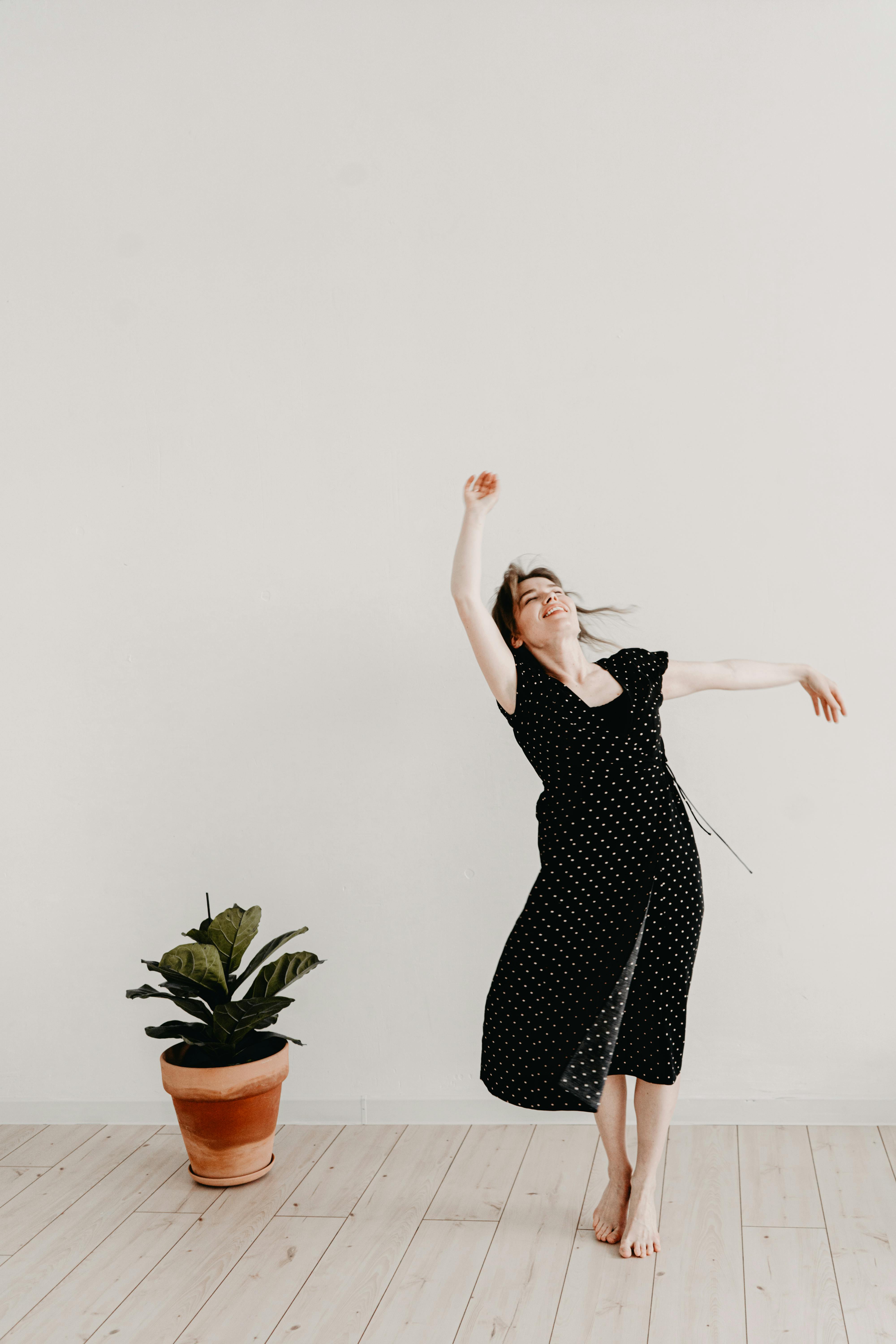 Free Woman Dancing Barefoot in a Dress Stock Photo