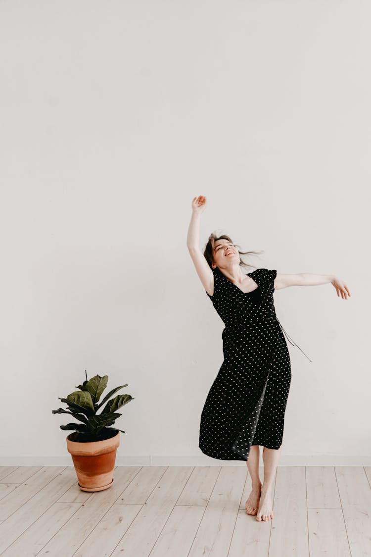 Woman Dancing Barefoot In A Dress