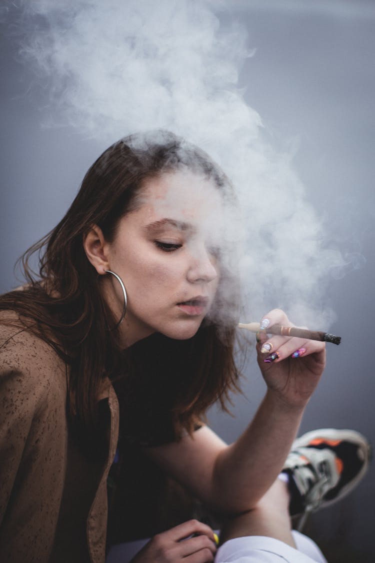 Teenage Girl Smoking A Cigar