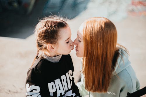 Mother and Daughter Kissing