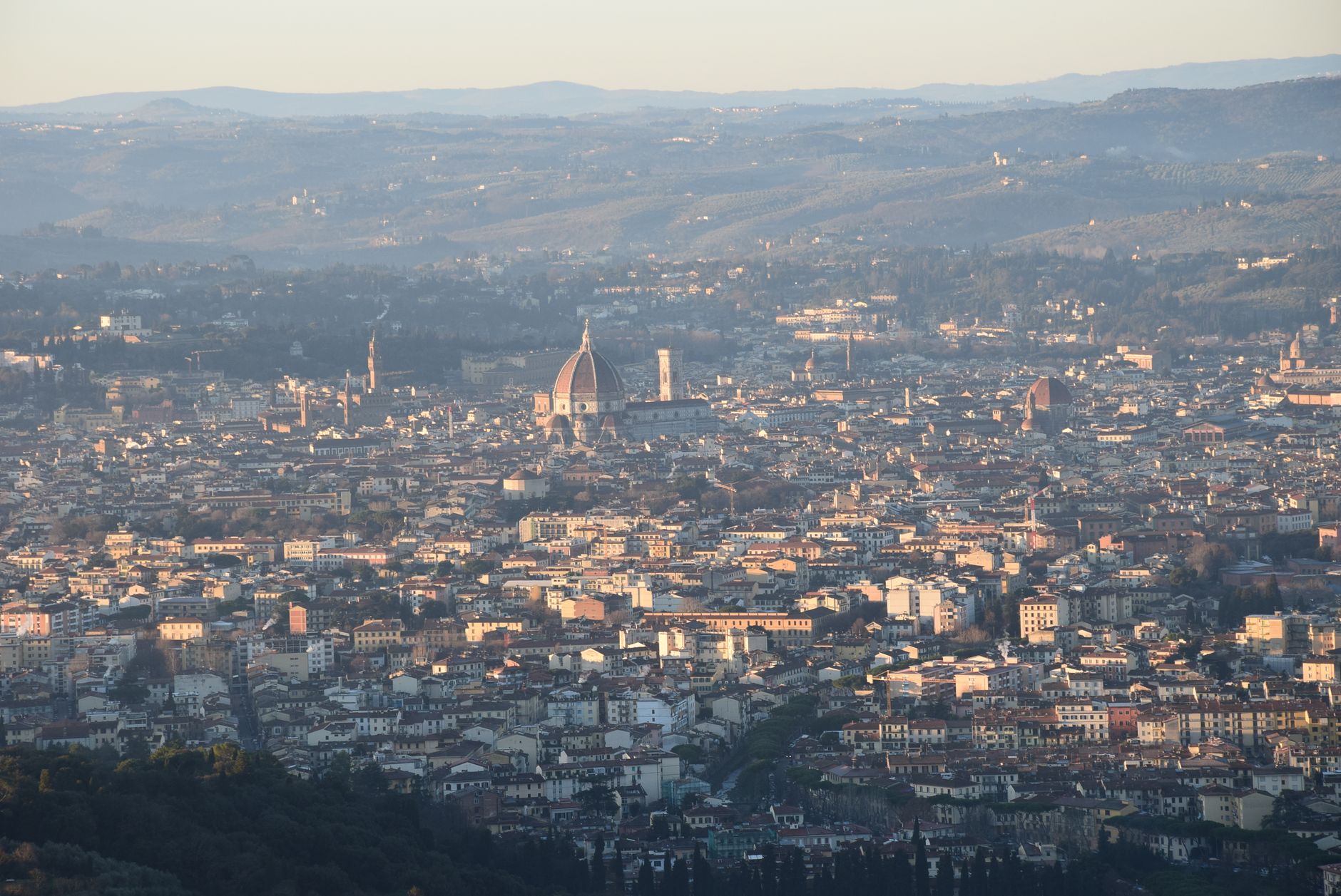 Aerial view of Florence at sunset highlighting iconic Renaissance architecture and scenic cityscape.