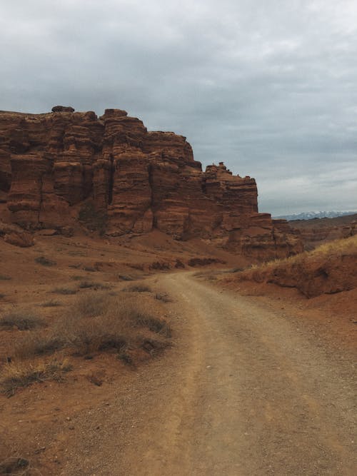 Brown Rock Formation Under Cloudy Sky