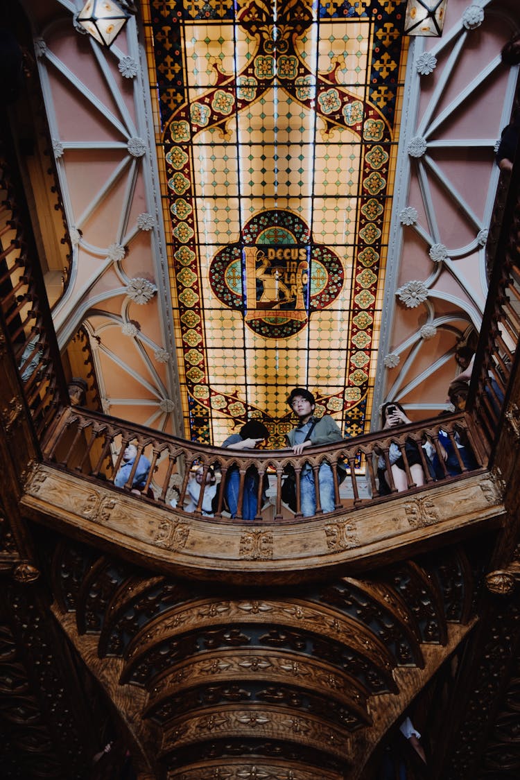 People Looking From Balustrade In Building