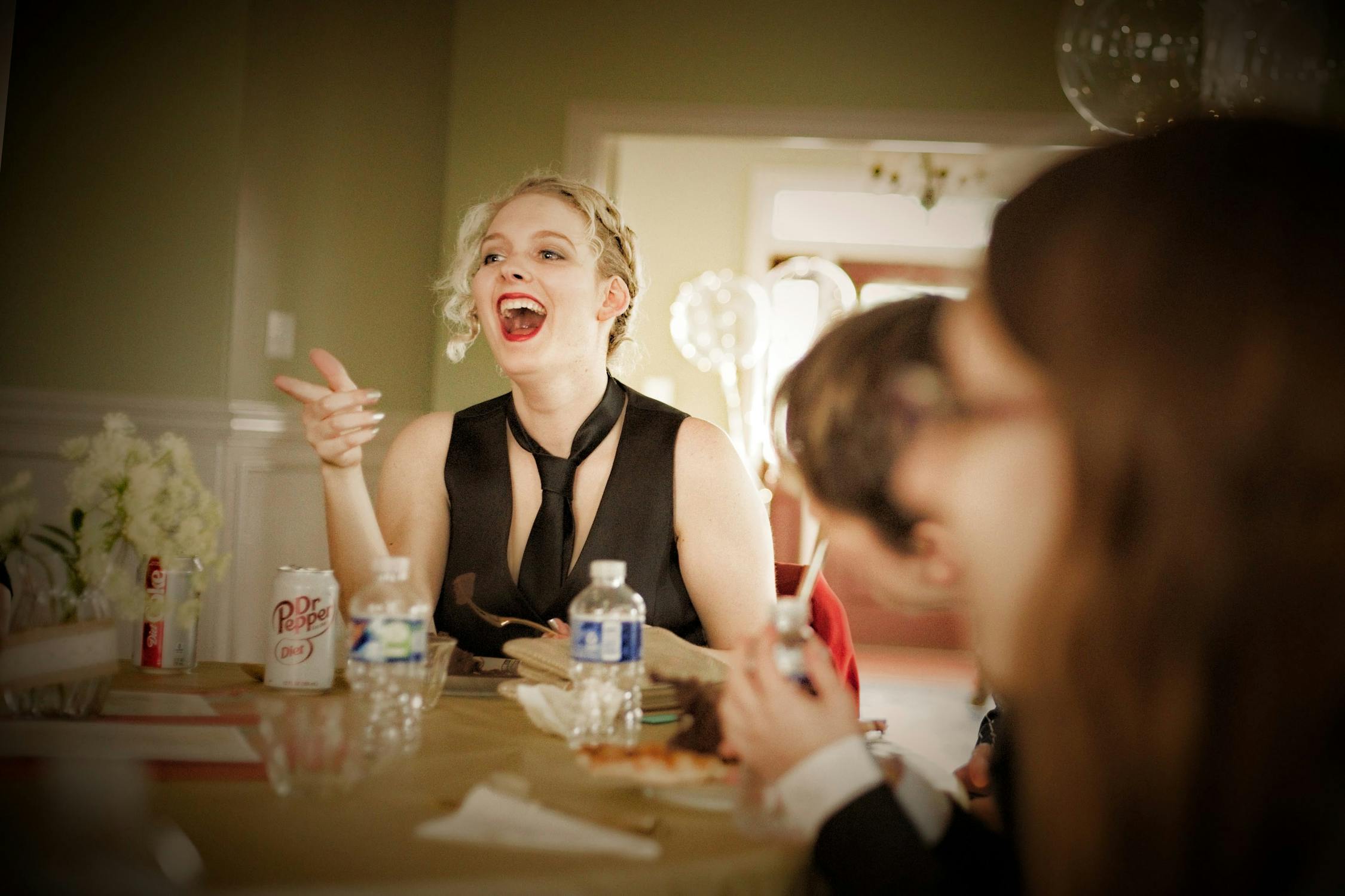 A Woman with a Necktie Laughing while Pointing