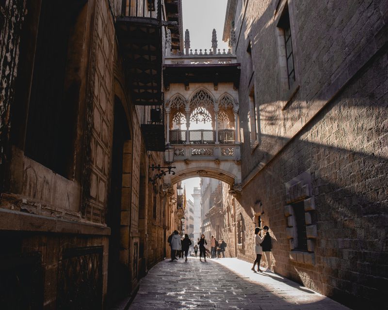 The Pont del Bisbe bridge spanning a narrow street in Barcelona's Gothic Quarter