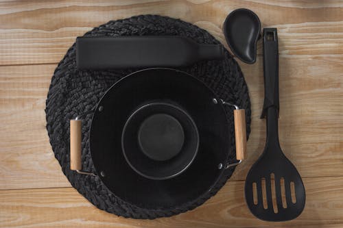 Free Black Ladle and Cookware on a Woven Mat Stock Photo