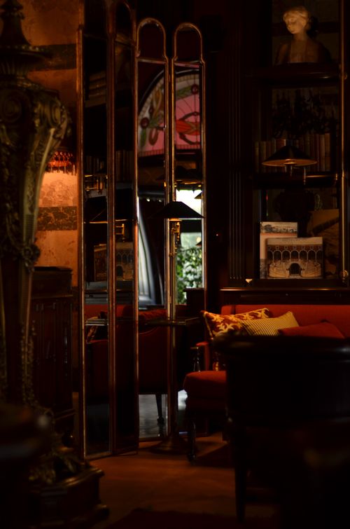 Free A warmly lit, retro café interior featuring vintage decor and elegant mirrors. Stock Photo