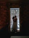 Woman in White Dress Standing Near Window