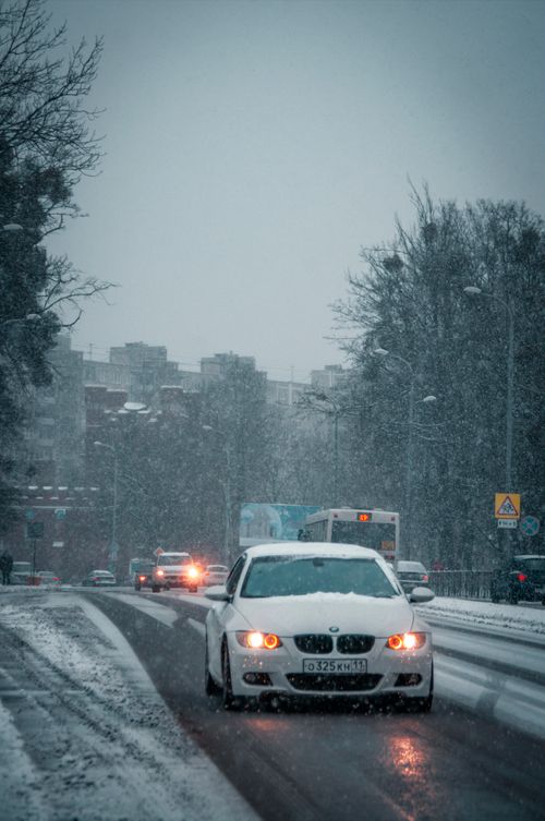 Free A car navigates a snowy street in Kaliningrad, Russia. Winter urban scene. Stock Photo