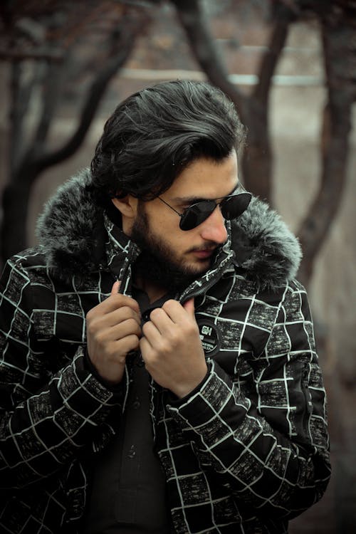 Man Wearing a Black Jacket and Sunglasses