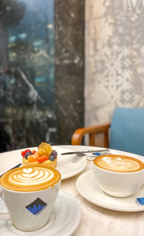 Close-up Shot of Coffee Art on Cups