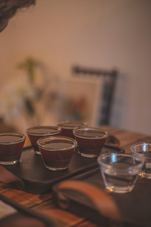 Free Clear Drinking Glasses on Brown Wooden Table Stock Photo