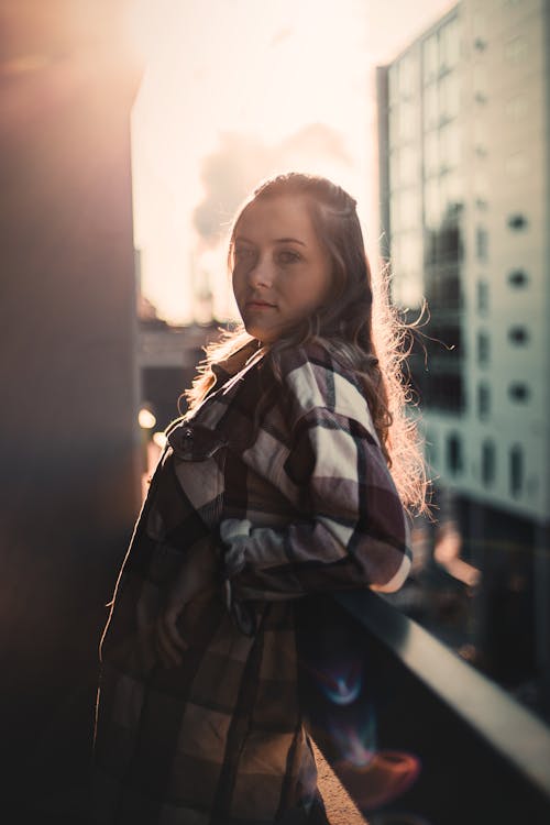 Selective Focus of a Woman Wearing Checkered Long Sleeves during Sunset