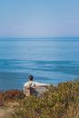 Back View of a Man Sitting on the Wooden Bench