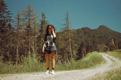 Woman Standing on the Dirty Road