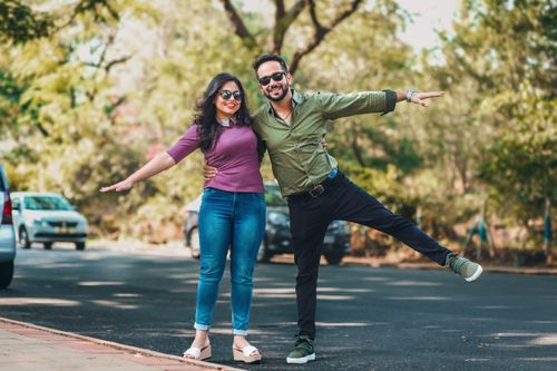 Free Happy couple playfully posing outdoors on a sunny day. Perfect for lifestyle imagery. Stock Photo