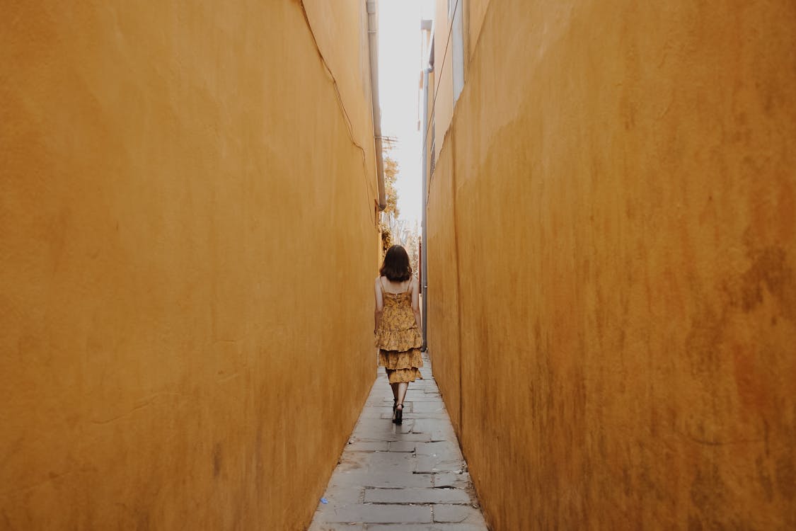 Photo of Woman Walk Through Pathway