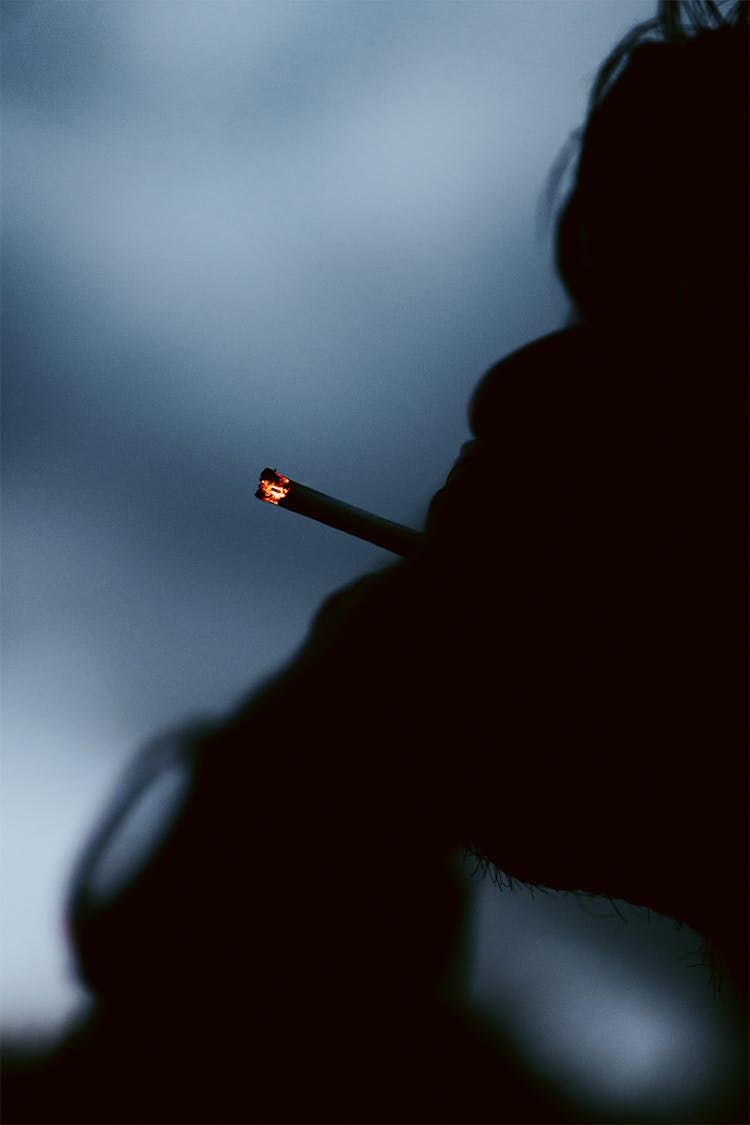 Silhouette Of A Person Smoking