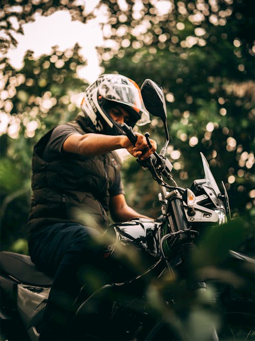Man Wearing Helmet Riding a Motorcycle