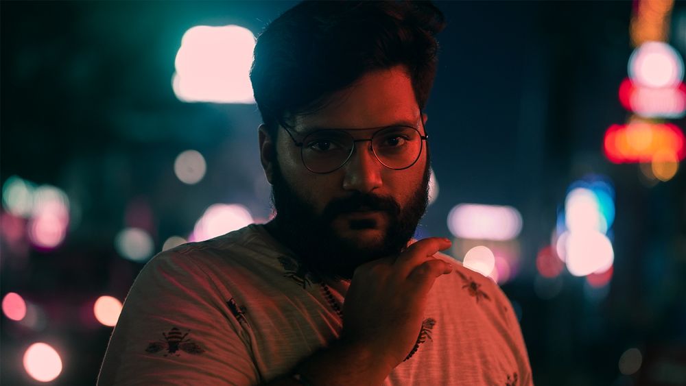 Close-up nighttime portrait of a bearded man wearing eyeglasses with bokeh backdrop., by Nandu Vasudevan on Pexels