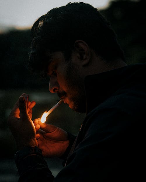 Bearded Man Lighting a Cigarette