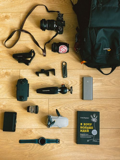 Free Photography equipment arranged stylishly on wooden floor for a creative flat lay. Stock Photo