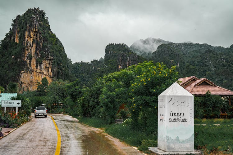 Car On A Road Towards The Mountain