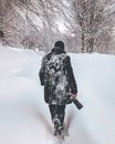 Back View of a Person Walking on the Snow Covered Ground